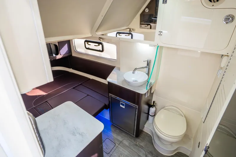  Yacht Photos Pics 2020 Scout 355 LXF cabin interior with bed, sink, and toilet.