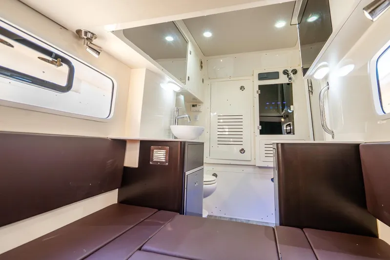  Yacht Photos Pics Luxurious interior of 2020 Scout 355 LXF boat with modern amenities and seating.