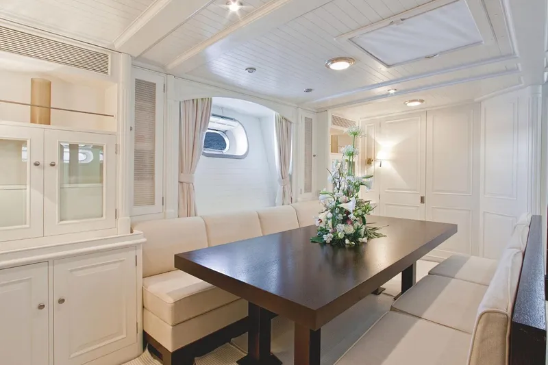 Mari Cha III Yacht Photos Pics Luxurious 1997 Sensation Yacht custom interior with elegant dining area and floral centerpiece.