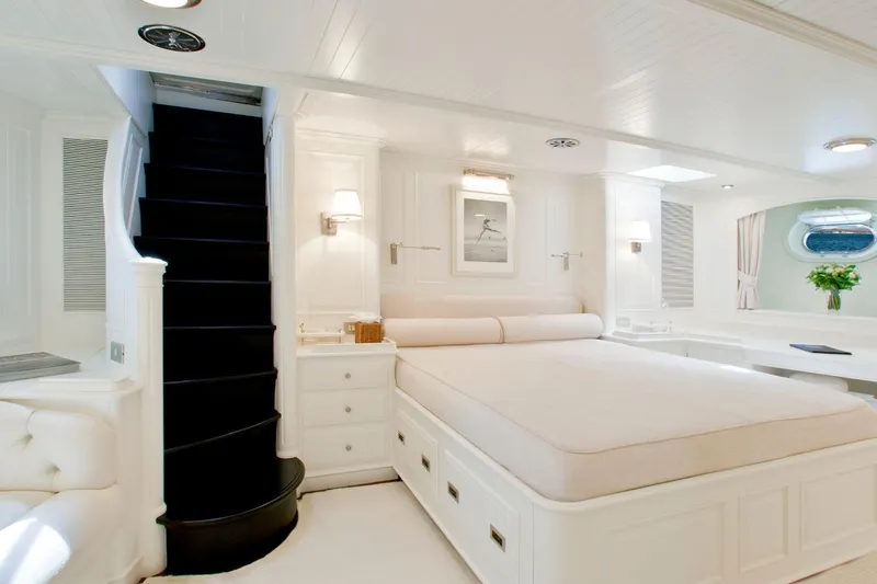 Mari Cha III Yacht Photos Pics Luxurious 1997 Sensation Yacht custom bedroom with elegant white decor and spiral staircase.