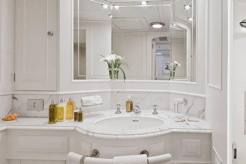 Mari Cha III Yacht Photos Pics Luxurious yacht bathroom with marble sink, elegant fixtures, and toiletries, 1997 Sensation Yacht Custom.
