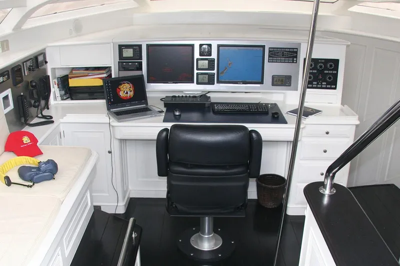Mari Cha III Yacht Photos Pics Control room of a 1997 Sensation Yacht, featuring navigation equipment and a black swivel chair.