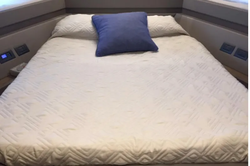  Yacht Photos Pics Luxurious bed in 2017 Ferreti 550 yacht cabin with blue pillow.