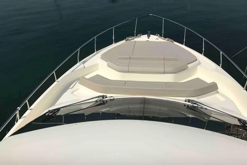  Yacht Photos Pics 2017 Ferreti 550 yacht bow with cushioned seating, overlooking calm water.