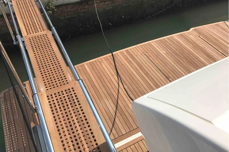  Yacht Photos Pics Teak deck and gangway of 2017 Ferreti 550 yacht by the water.
