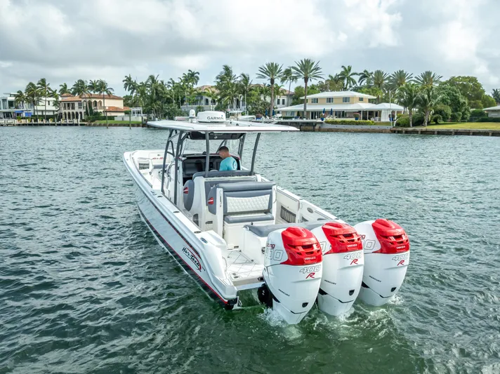  Yacht Photos Pics 2018 Nor-Tech 390 boat with triple outboard engines cruising on a scenic waterway.
