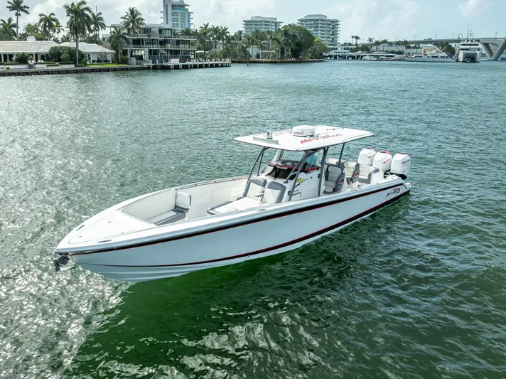  Yacht Photos Pics 2018 Nor-Tech 390 boat cruising on a sunny waterfront with modern buildings in the background.
