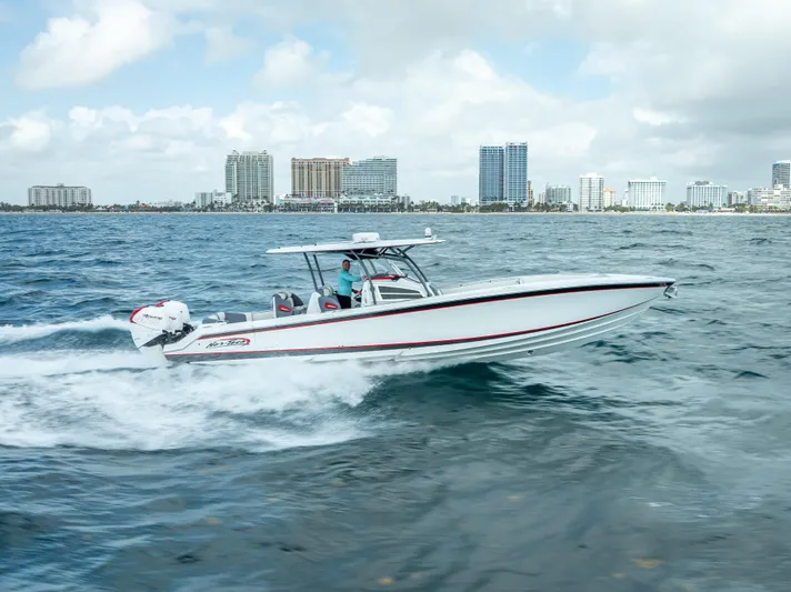  Yacht Photos Pics 2018 Nor-Tech 390 boat cruising on ocean near city skyline.