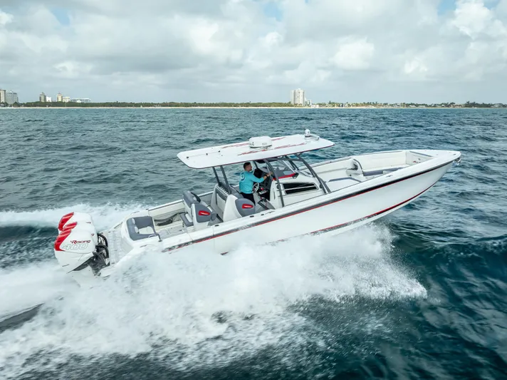  Yacht Photos Pics 2018 Nor-Tech 390 boat cruising on open water under a cloudy sky.