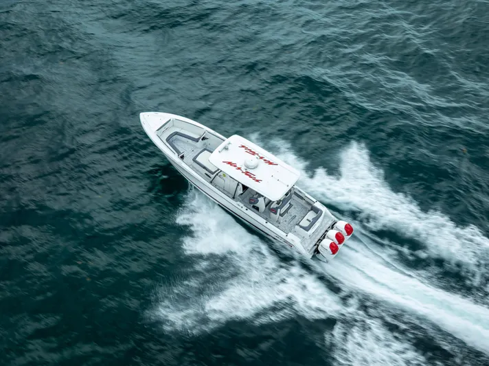  Yacht Photos Pics Aerial view of 2018 Nor-Tech 390 boat speeding on open water.