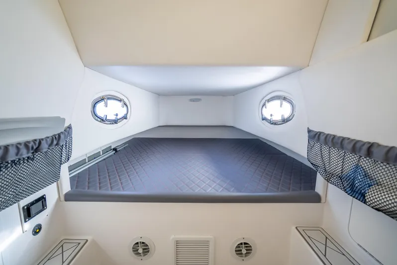  Yacht Photos Pics 2018 Nor-Tech 390 cabin interior with bed, portholes, and storage nets.