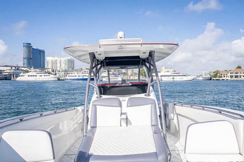  Yacht Photos Pics 2018 Nor-Tech 390 boat on water, city skyline in background, clear blue sky.
