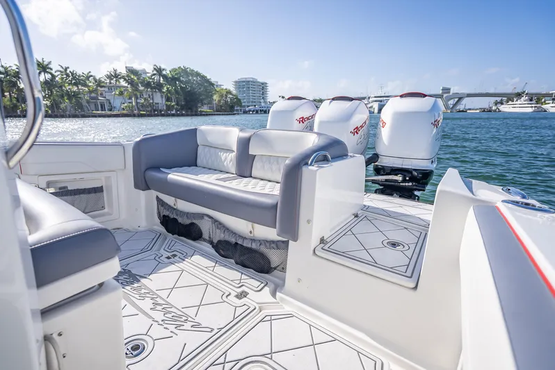  Yacht Photos Pics 2018 Nor-Tech 390 boat interior with seating and multiple outboard engines on a sunny day.