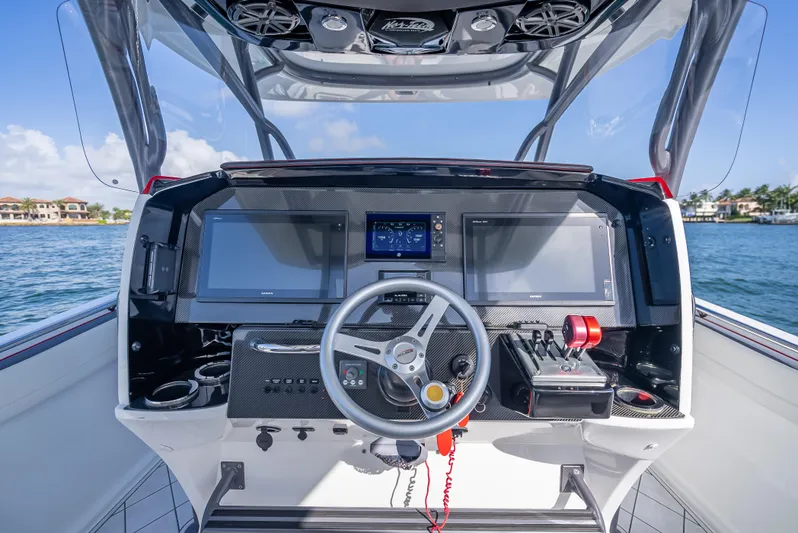  Yacht Photos Pics 2018 Nor-Tech 390 boat dashboard with modern controls and navigation screens on a sunny day.