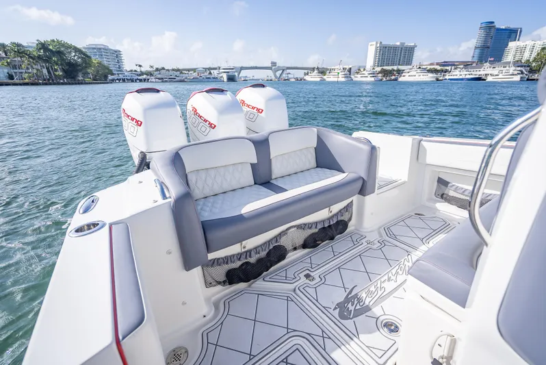  Yacht Photos Pics 2018 Nor-Tech 390 boat with triple engines, luxurious seating, and scenic waterfront view.