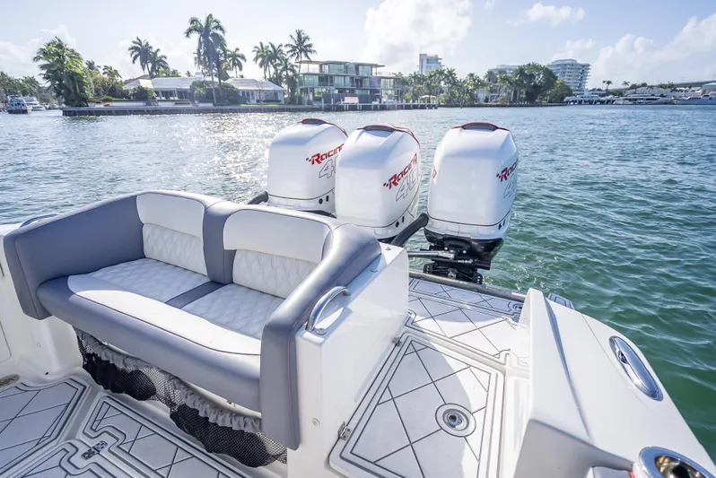  Yacht Photos Pics 2018 Nor-Tech 390 boat with triple engines, luxurious seating, and scenic waterfront view.