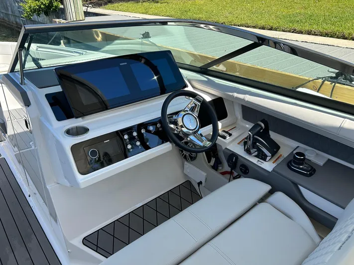  Yacht Photos Pics 2023 Sea Ray SLX 310 OB boat cockpit with modern controls and steering wheel.