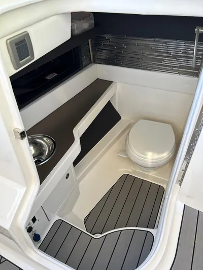  Yacht Photos Pics 2023 Sea Ray SLX 310 OB boat interior with toilet and sink.