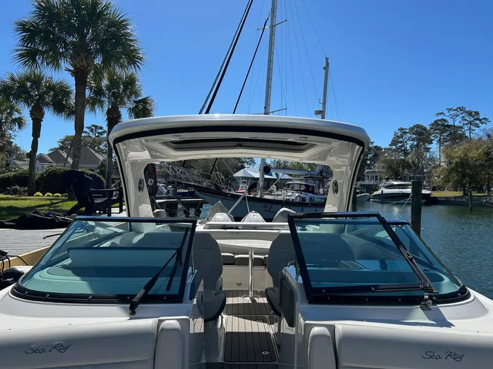  Yacht Photos Pics 2023 Sea Ray SLX 310 OB boat docked, featuring sleek design and spacious seating.