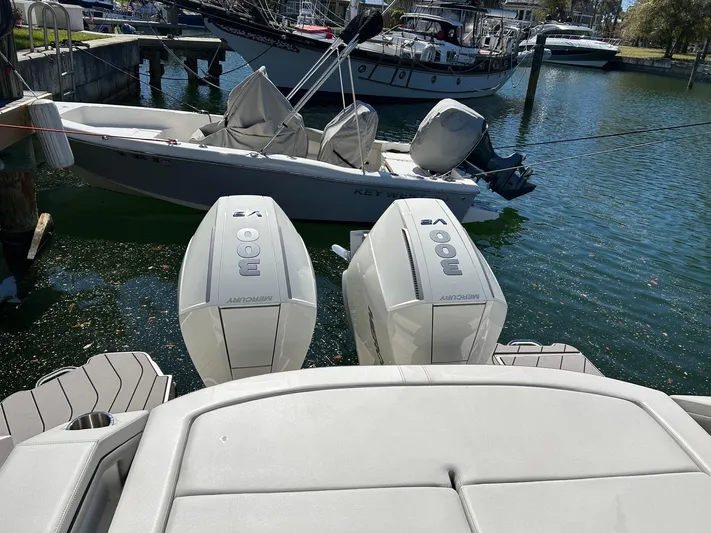  Yacht Photos Pics 2023 Sea Ray SLX 310 OB with twin outboard engines docked in a marina.
