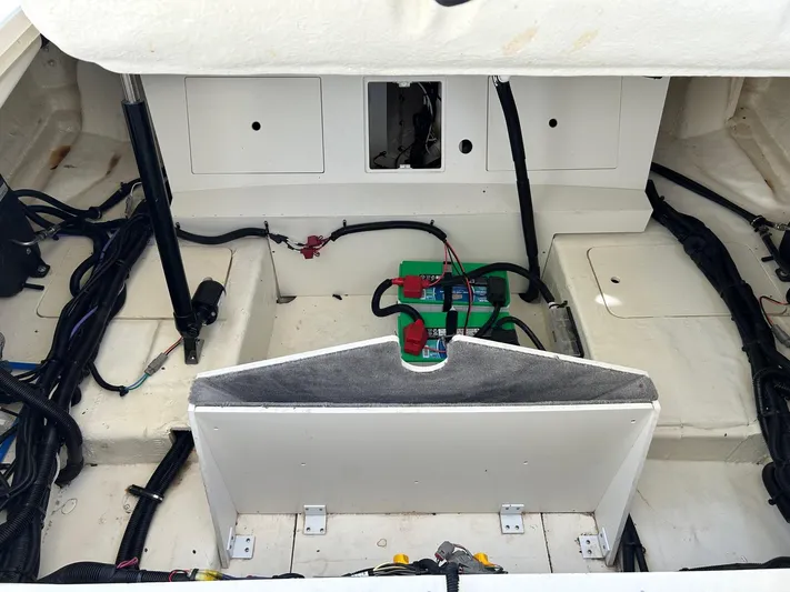  Yacht Photos Pics Engine compartment of 2023 Sea Ray SLX 310 OB boat, showcasing wiring and battery setup.