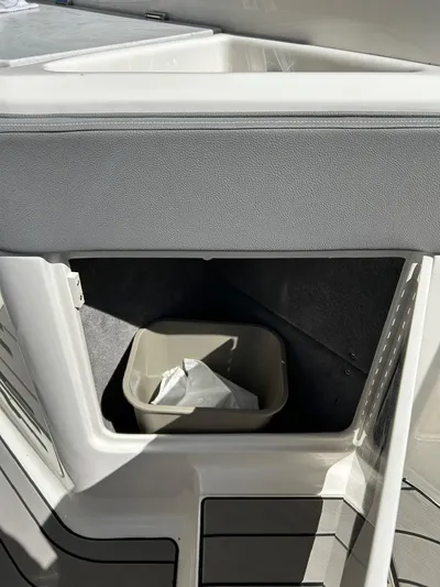  Yacht Photos Pics 2023 Sea Ray SLX 310 OB storage compartment with trash bin.