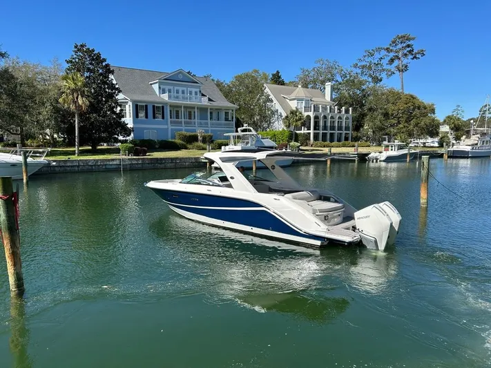  Yacht Photos Pics 2023 Sea Ray SLX 310 OB boat docked near waterfront homes.