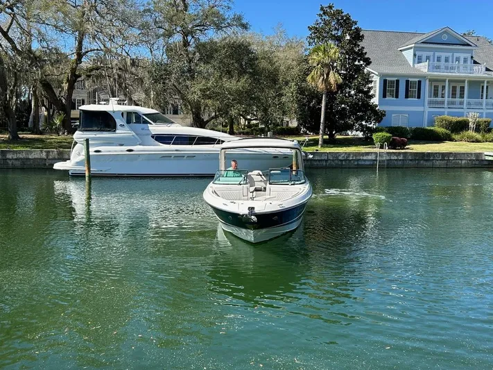  Yacht Photos Pics 2023 Sea Ray SLX 310 OB boat docked in a serene waterfront setting.
