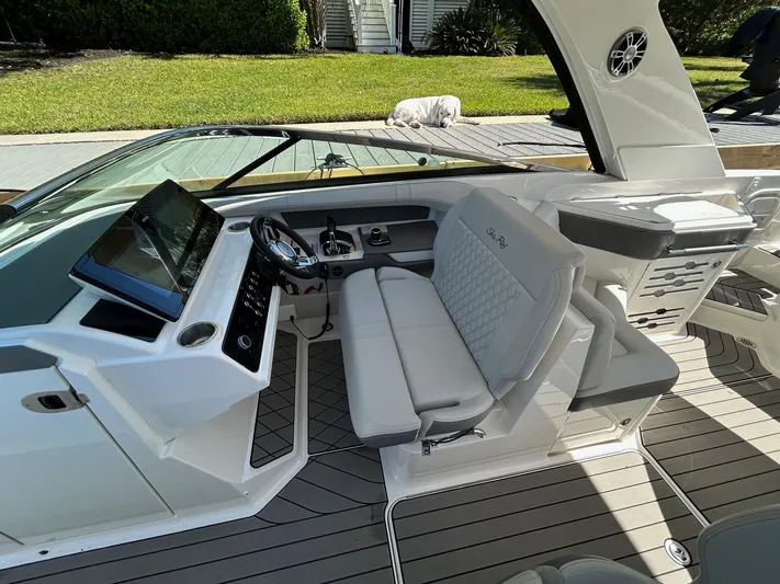  Yacht Photos Pics 2023 Sea Ray SLX 310 OB boat interior with modern helm and seating.
