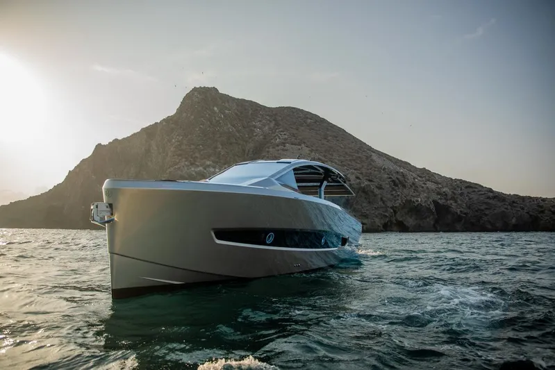  Yacht Photos Pics Luxury Tesoro T50 Armani Casa yacht cruising near rocky island, 2025 model.