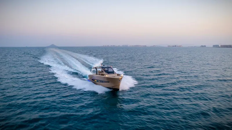  Yacht Photos Pics 2025 Tesoro T50 Armani Casa Speciale yacht cruising on open water at sunset.
