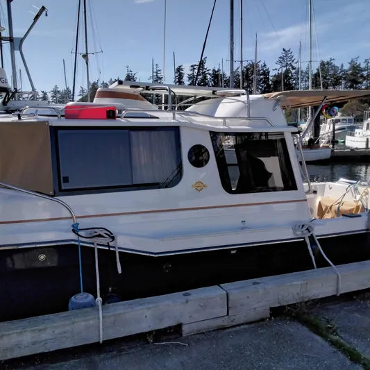  Yacht Photos Pics 2023 Ranger Tugs R-25 boat docked at a marina.