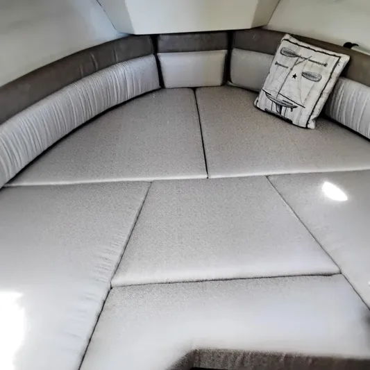  Yacht Photos Pics 2023 Ranger Tugs R-25 interior cabin with cushioned seating and decorative pillow.