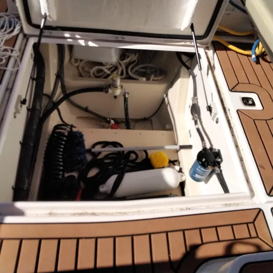 Yacht Photos Pics Open storage compartment of 2023 Ranger Tugs R-25 boat with various equipment and tools.