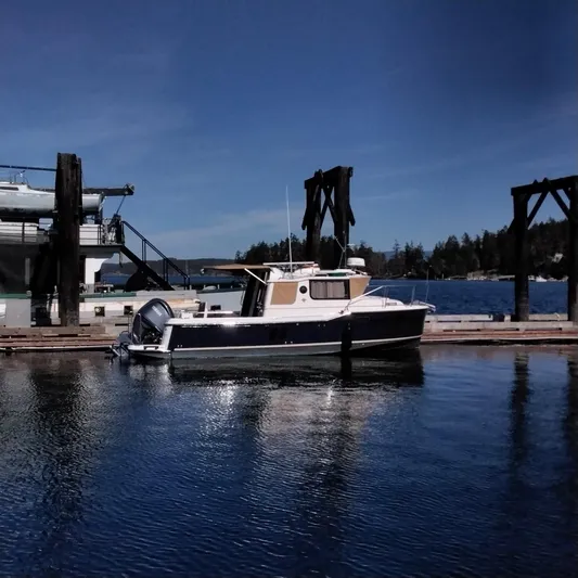  Yacht Photos Pics 2023 Ranger Tugs R-25 boat docked at a marina on a sunny day.