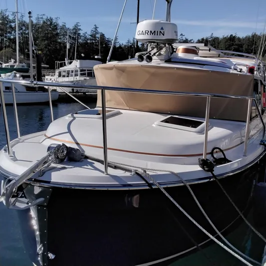  Yacht Photos Pics 2023 Ranger Tugs R-25 boat docked, featuring Garmin navigation equipment.