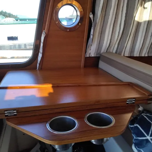  Yacht Photos Pics Interior of 2023 Ranger Tugs R-25 with wooden table and cup holders.