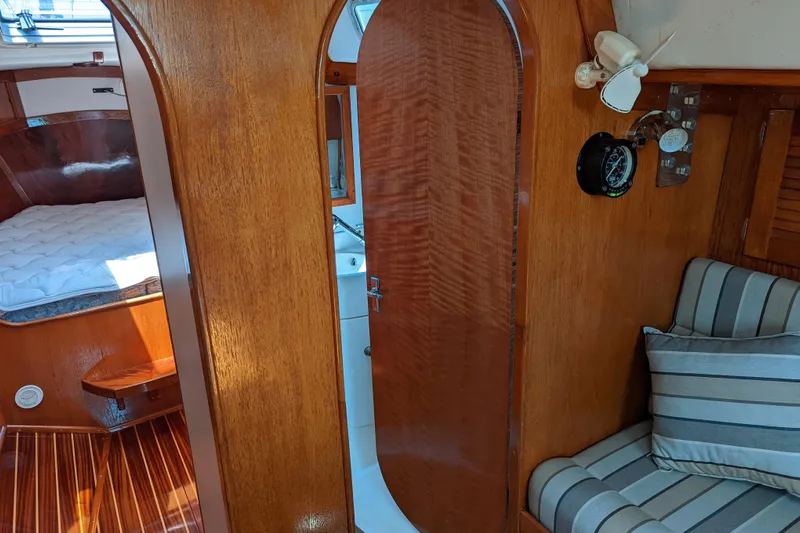 Ardent Yacht Photos Pics Interior of 1993 J Boats J/130 sailboat with wood finish and striped seating.