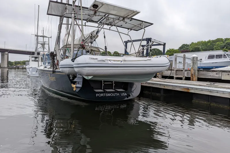 Ardent Yacht Photos Pics 1993 J Boats J/130 sailboat docked in Portsmouth, USA, with dinghy on stern.