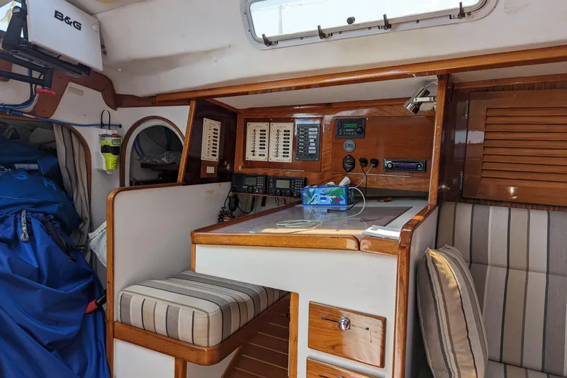Ardent Yacht Photos Pics Interior of 1993 J Boats J/130 sailboat with navigation equipment and seating area.