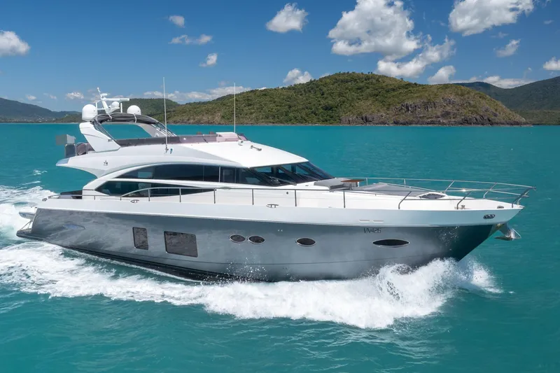 About Time Yacht Photos Pics 2014 Princess Flybridge 72 Motor Yacht cruising on turquoise waters, scenic island backdrop.