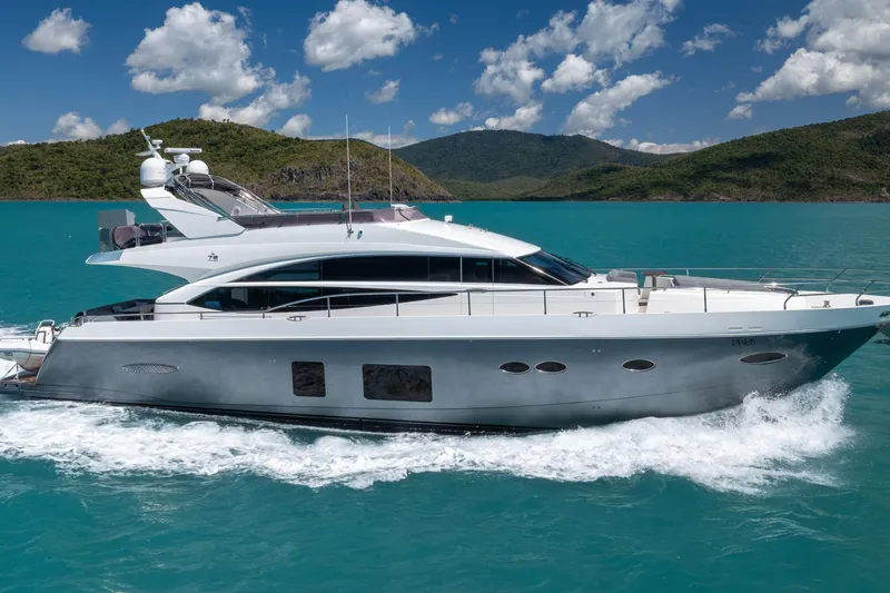 About Time Yacht Photos Pics 2014 Princess Flybridge 72 Motor Yacht cruising on turquoise waters, scenic backdrop.