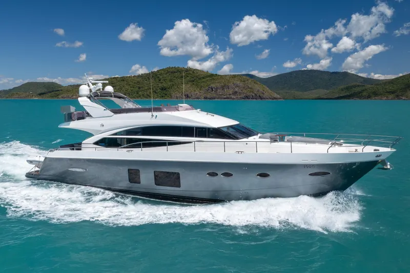 About Time Yacht Photos Pics 2014 Princess Flybridge 72 Motor Yacht cruising on turquoise waters.