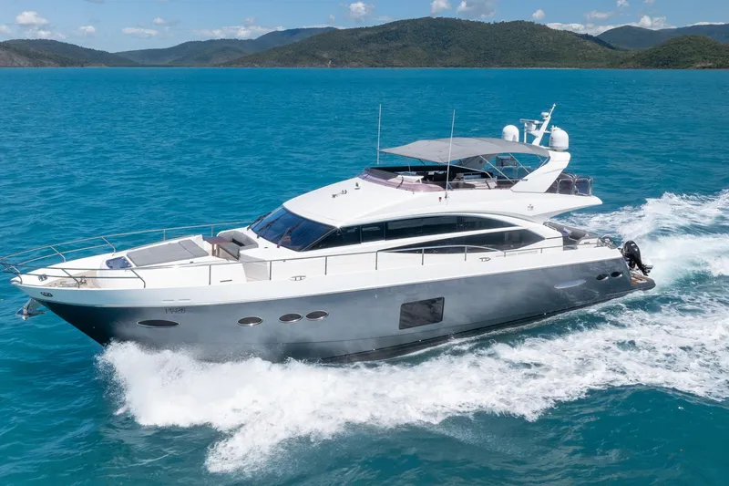 About Time Yacht Photos Pics 2014 Princess Flybridge 72 Motor Yacht cruising on turquoise waters.