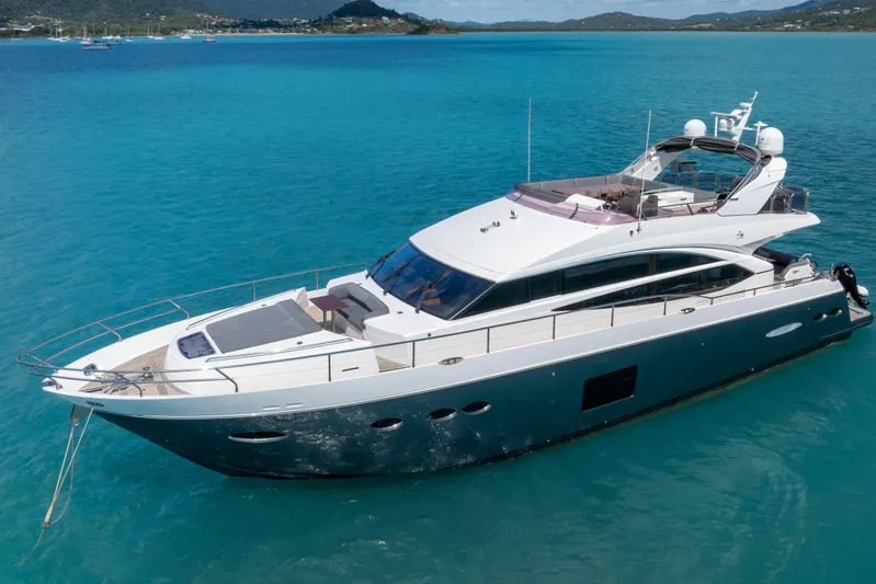 About Time Yacht Photos Pics 2014 Princess Flybridge 72 Motor Yacht on turquoise water, scenic background.