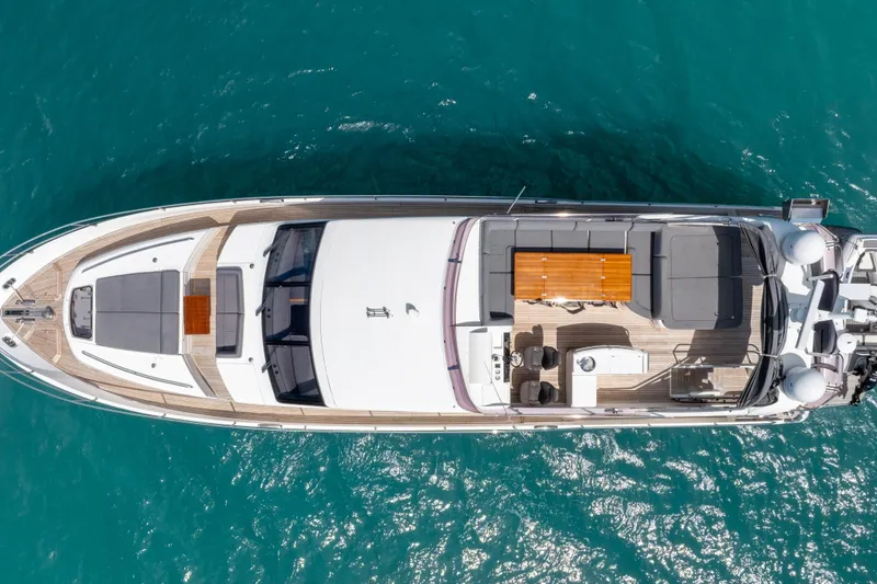About Time Yacht Photos Pics Overhead view of 2014 Princess Flybridge 72 Motor Yacht on turquoise water.