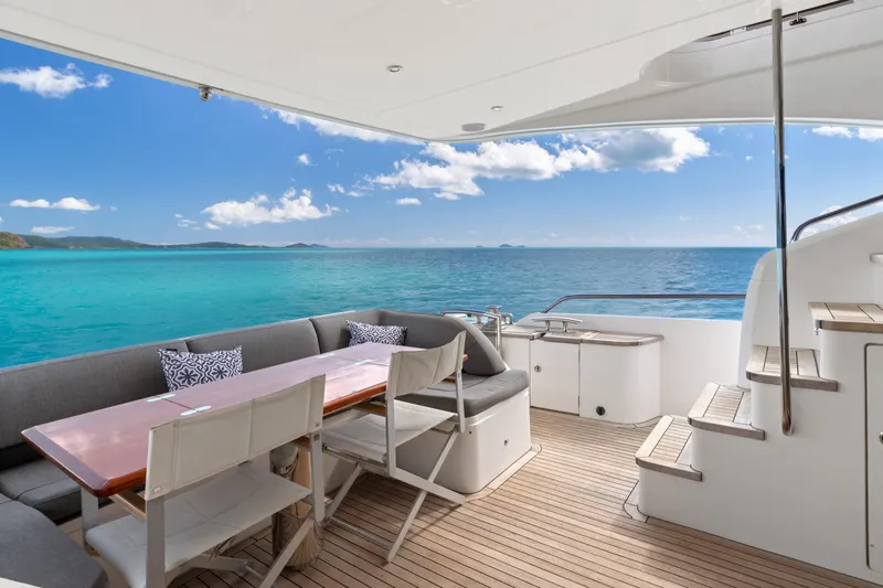 About Time Yacht Photos Pics Luxurious 2014 Princess Flybridge 72 Motor Yacht with elegant outdoor seating and stunning ocean view.