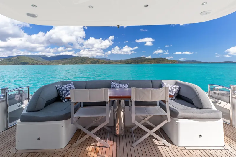 About Time Yacht Photos Pics Luxurious 2014 Princess Flybridge 72 Motor Yacht with scenic ocean view and elegant seating area.