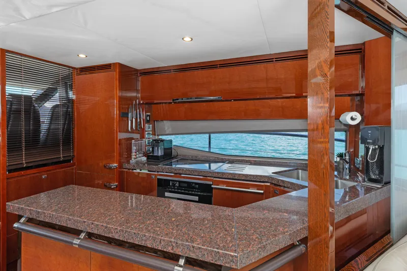 About Time Yacht Photos Pics Luxurious kitchen interior of 2014 Princess Flybridge 72 Motor Yacht with ocean view.