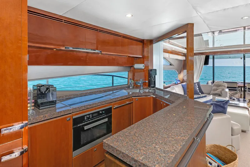 About Time Yacht Photos Pics Luxurious kitchen interior of 2014 Princess Flybridge 72 Motor Yacht with ocean view.